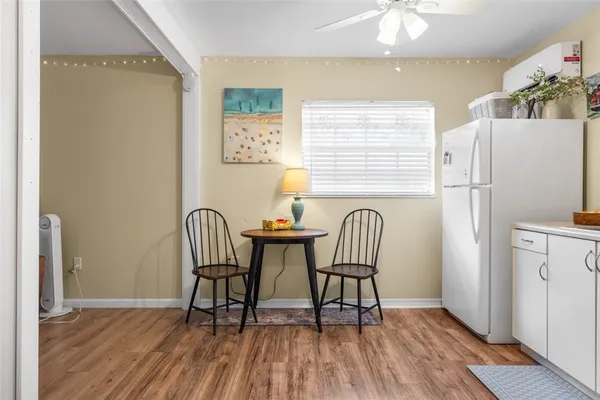 a dining room with furniture and wooden floor
