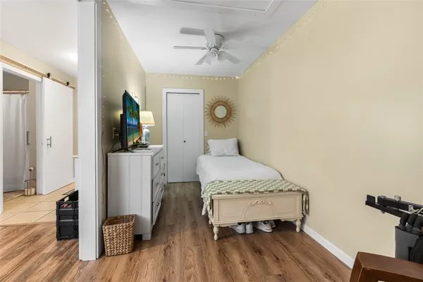 a bedroom with a bed and wooden floor