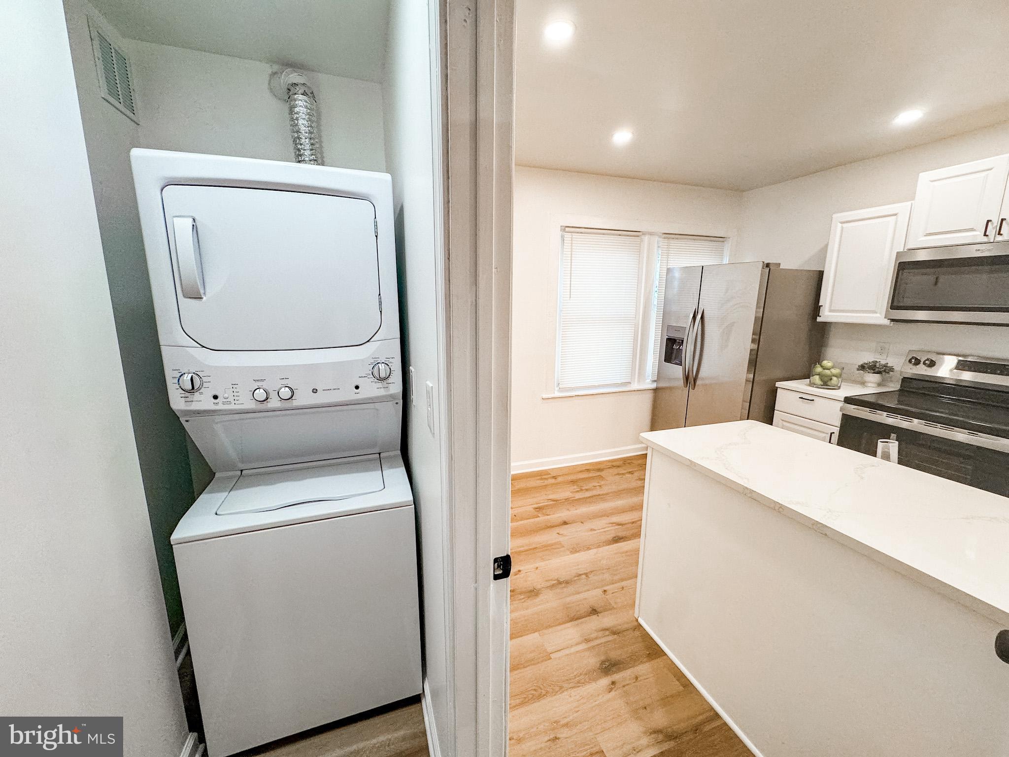 217 Ridge Road Claymont, DE 19703 - Photo 11 of 18 a view of washer and dryer with kitchen in the background