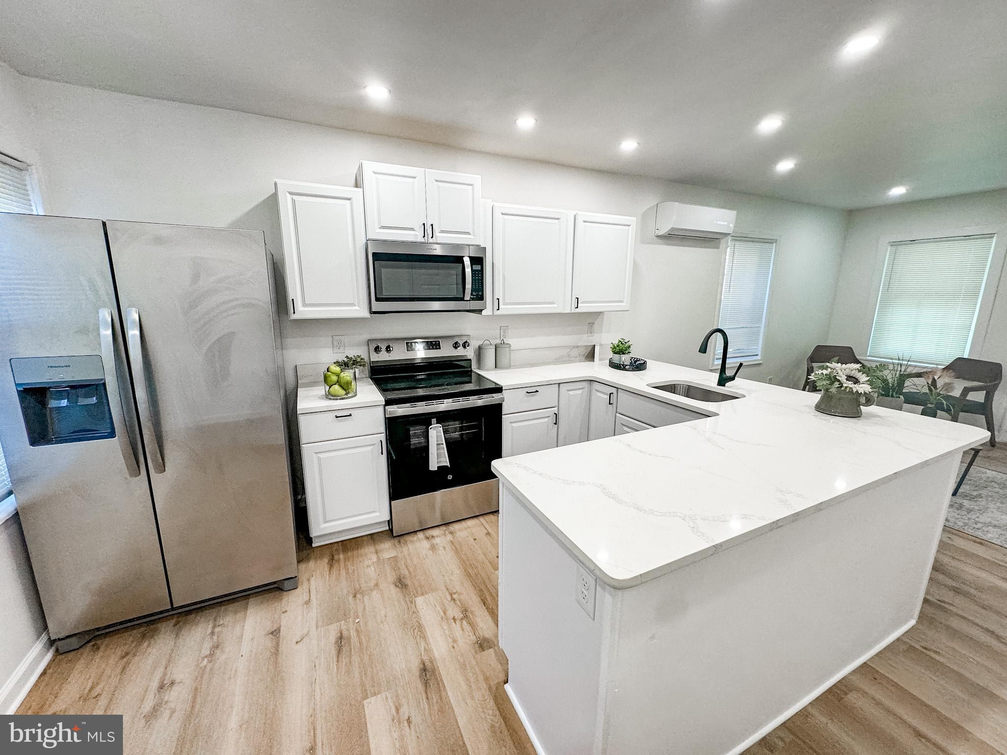 217 Ridge Road Claymont, DE 19703 - Photo 7 of 18 a kitchen with stainless steel appliances a refrigerator stove microwave and sink