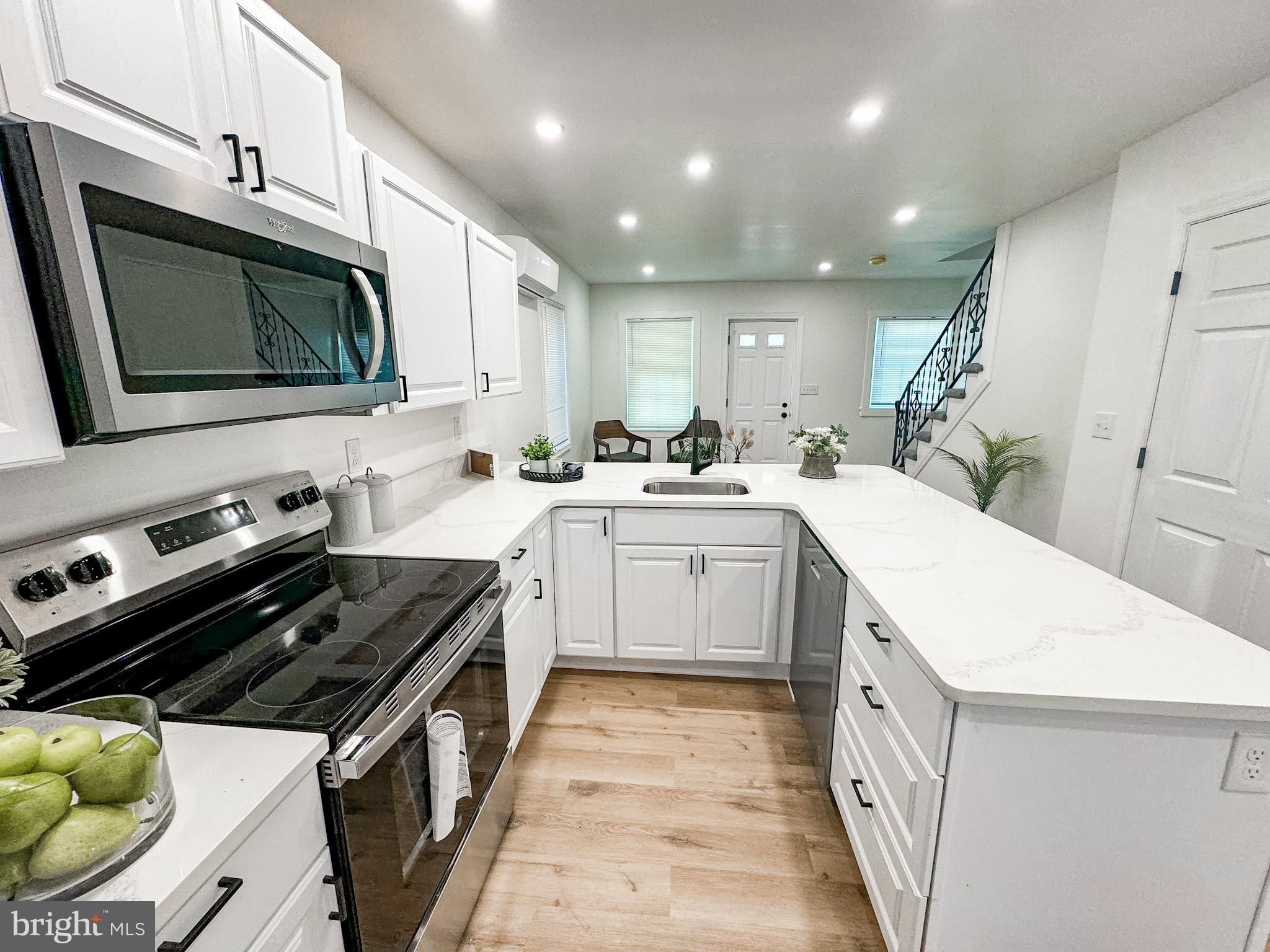 217 Ridge Road Claymont, DE 19703 - Photo 8 of 18 a kitchen that has a sink wooden cabinets and stainless steel appliances