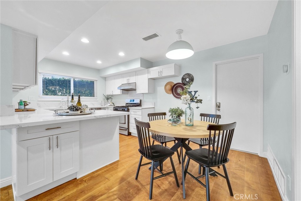 1528 North Gilbert Street Fullerton, CA 92833 - Photo 14 of 40 a view of a dining room with furniture and wooden floor