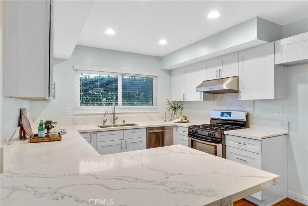1528 North Gilbert Street Fullerton, CA 92833 - Photo 18 of 40 a kitchen with stainless steel appliances granite countertop a sink stove refrigerator and cabinets