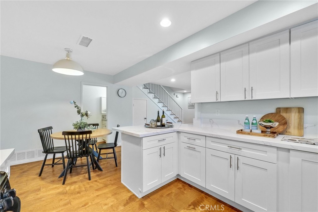 1528 North Gilbert Street Fullerton, CA 92833 - Photo 21 of 40 a kitchen with a table chairs and white cabinets