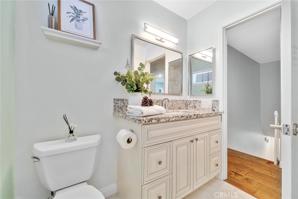 1528 North Gilbert Street Fullerton, CA 92833 - Photo 26 of 40 a bathroom with a granite countertop sink mirror and toilet
