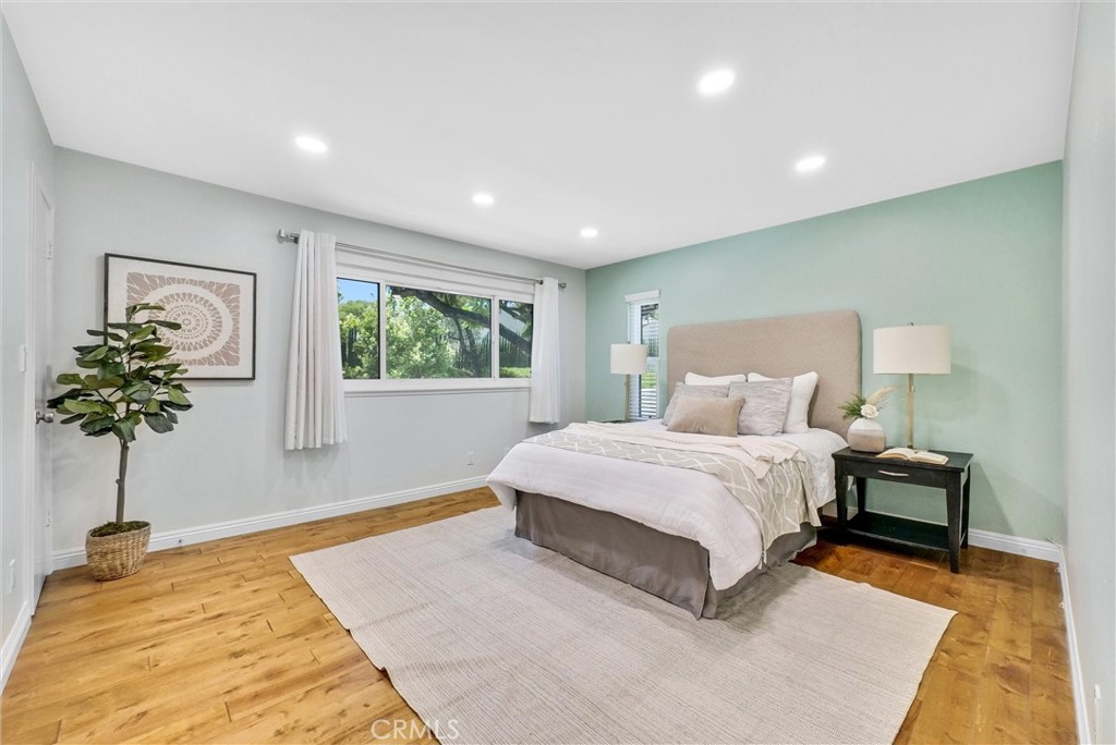 1528 North Gilbert Street Fullerton, CA 92833 - Photo 28 of 40 a spacious bedroom with a bed lamp on table and a window
