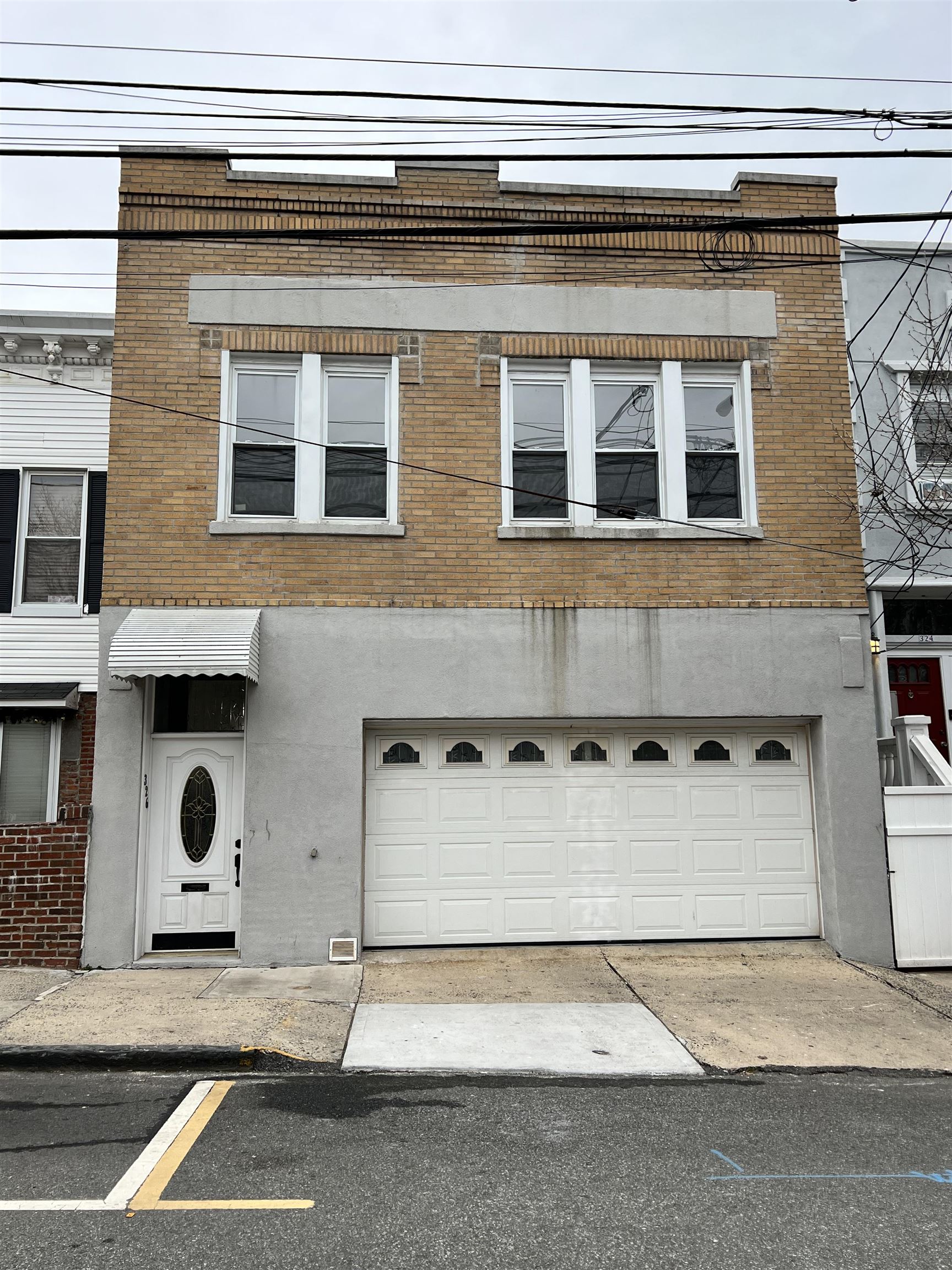 a front view of a house with a parking space