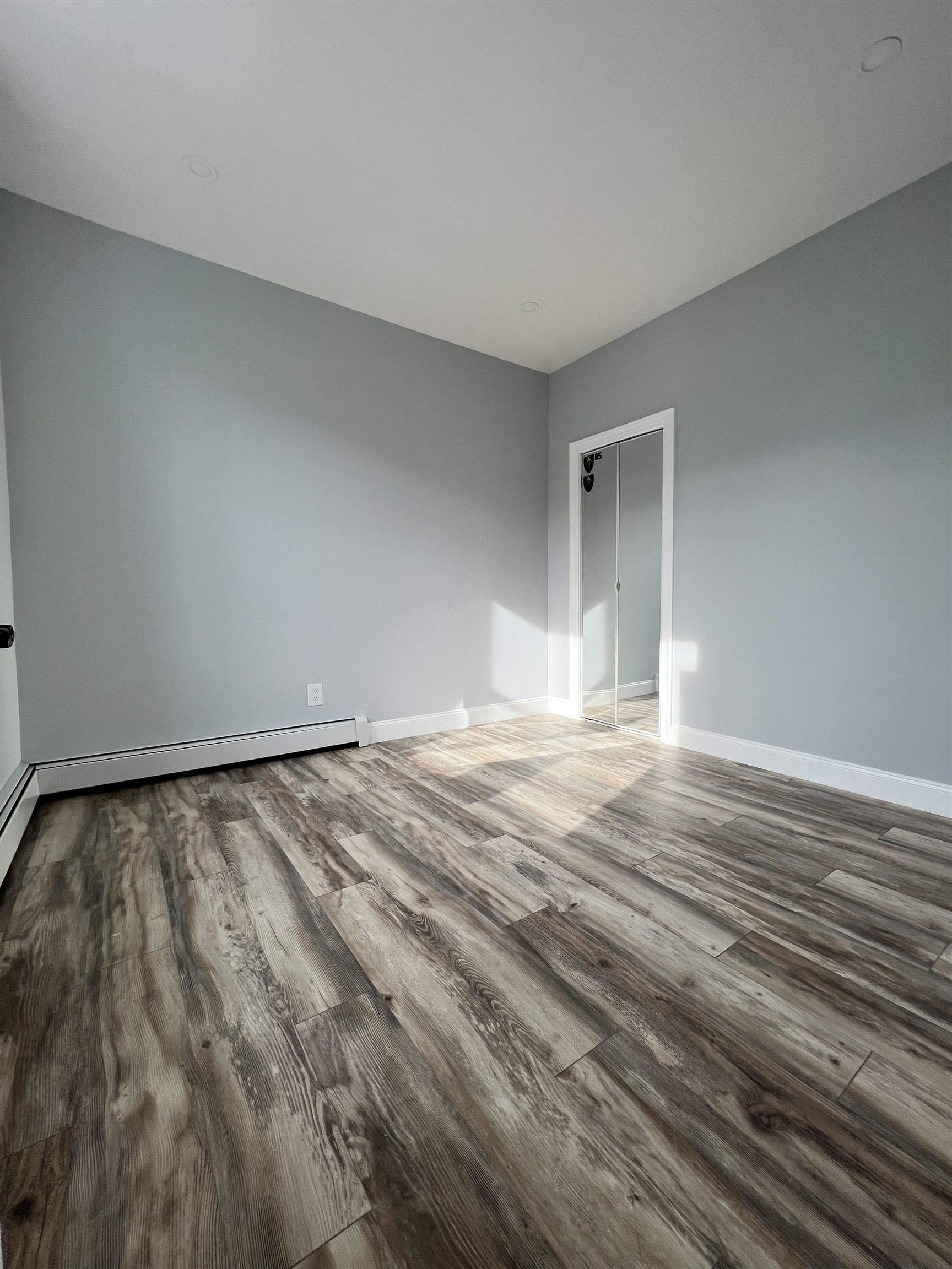 326 70th Street Guttenberg, NJ 07093 - Photo 12 of 15 a view of empty room with wooden floor