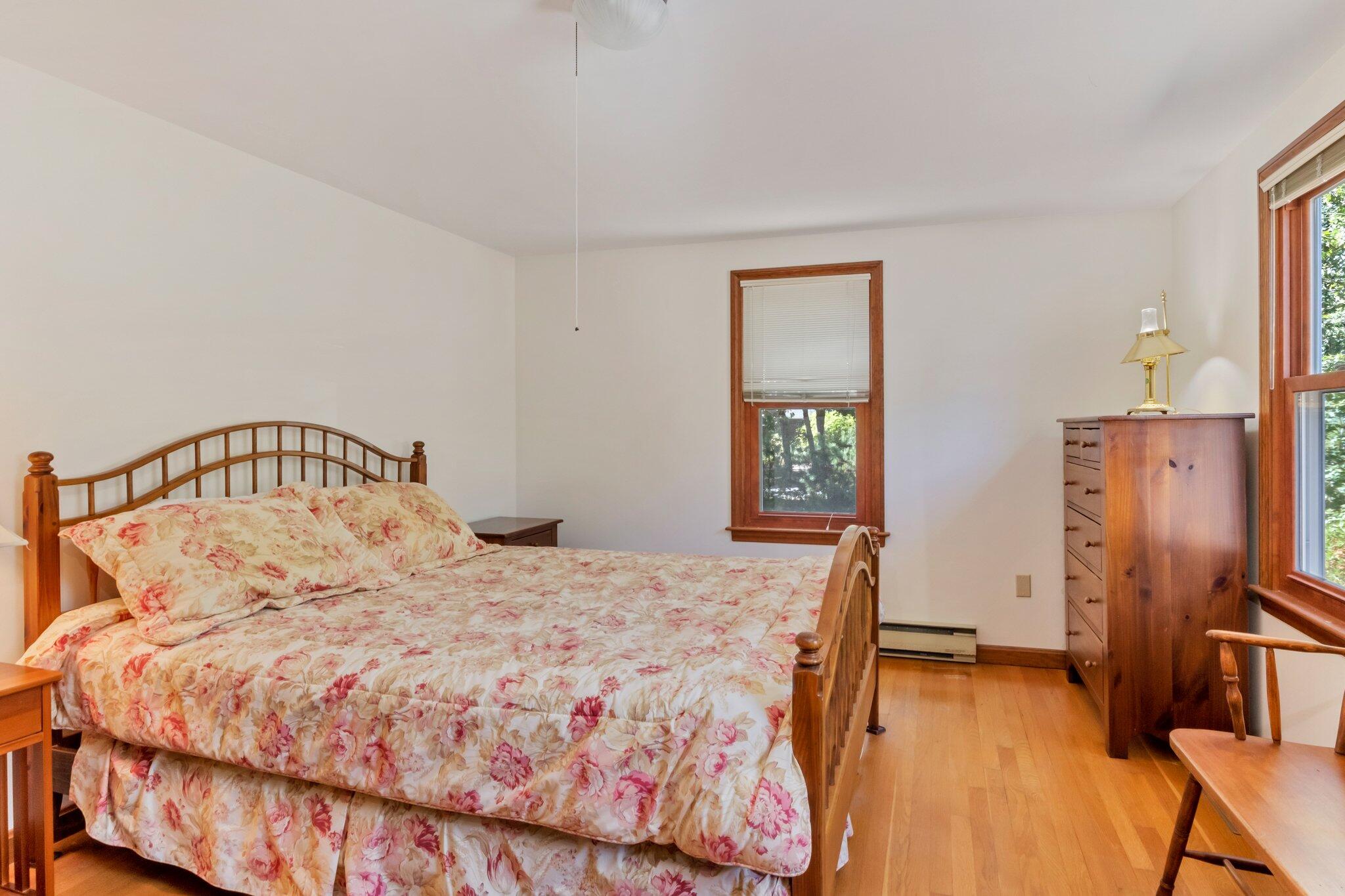 15 Chipmunk Lane Eastham, MA 02642 - Photo 13 of 32 a bedroom with a bed and a table in it