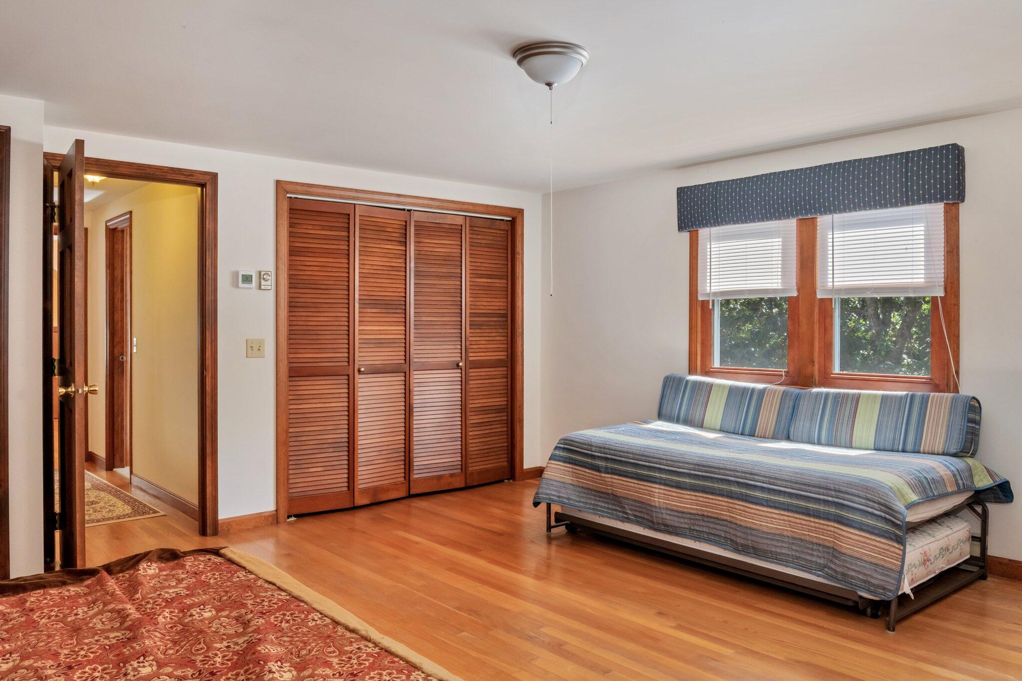 15 Chipmunk Lane Eastham, MA 02642 - Photo 19 of 32 a bedroom with a bed and wooden floor