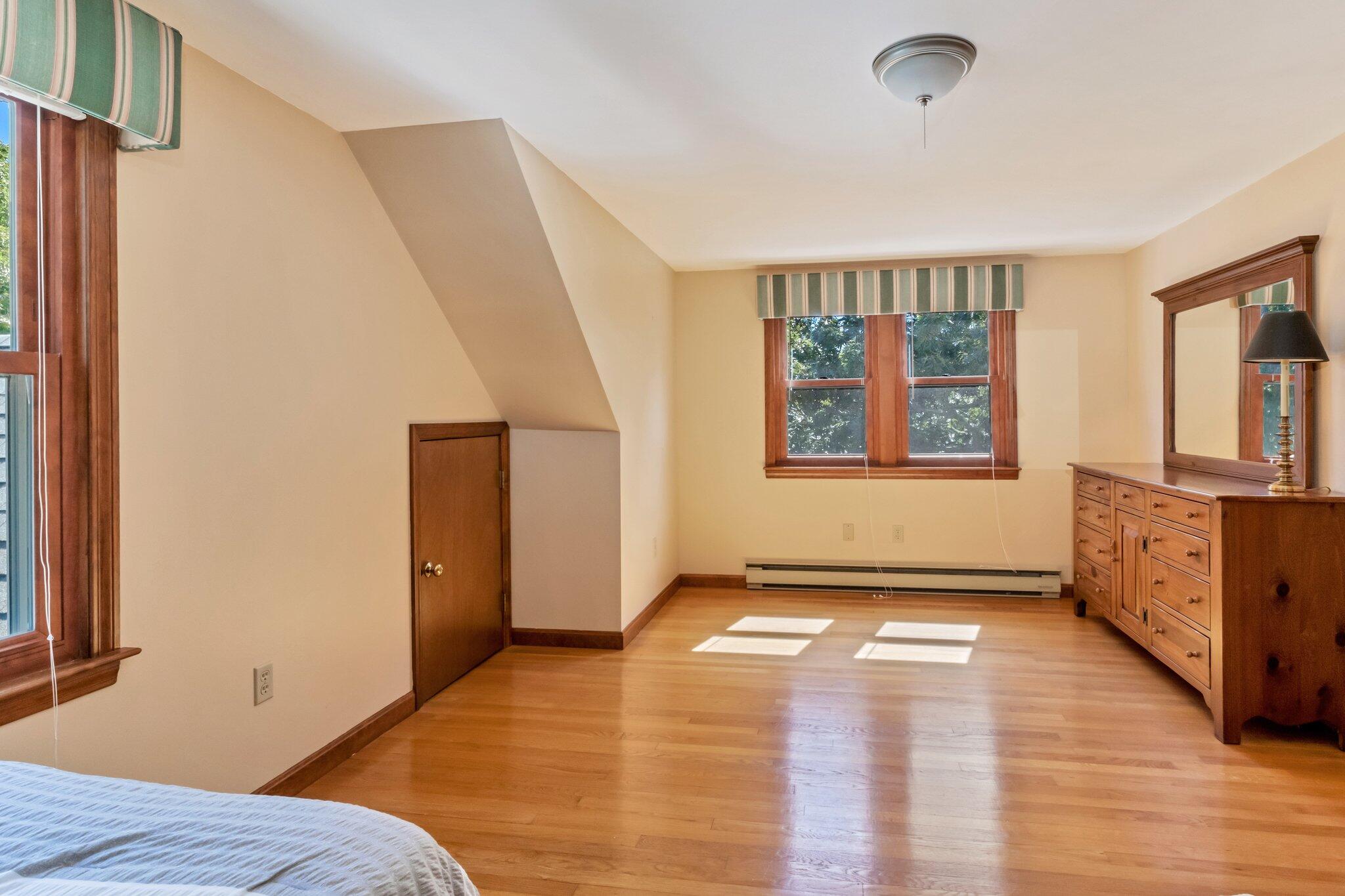 15 Chipmunk Lane Eastham, MA 02642 - Photo 22 of 32 a view of an empty room with a window and wooden floor