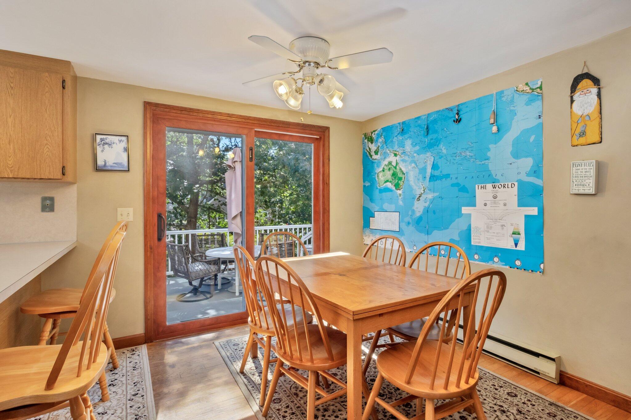 15 Chipmunk Lane Eastham, MA 02642 - Photo 8 of 32 a view of a dining room with furniture a chandelier and wooden floor