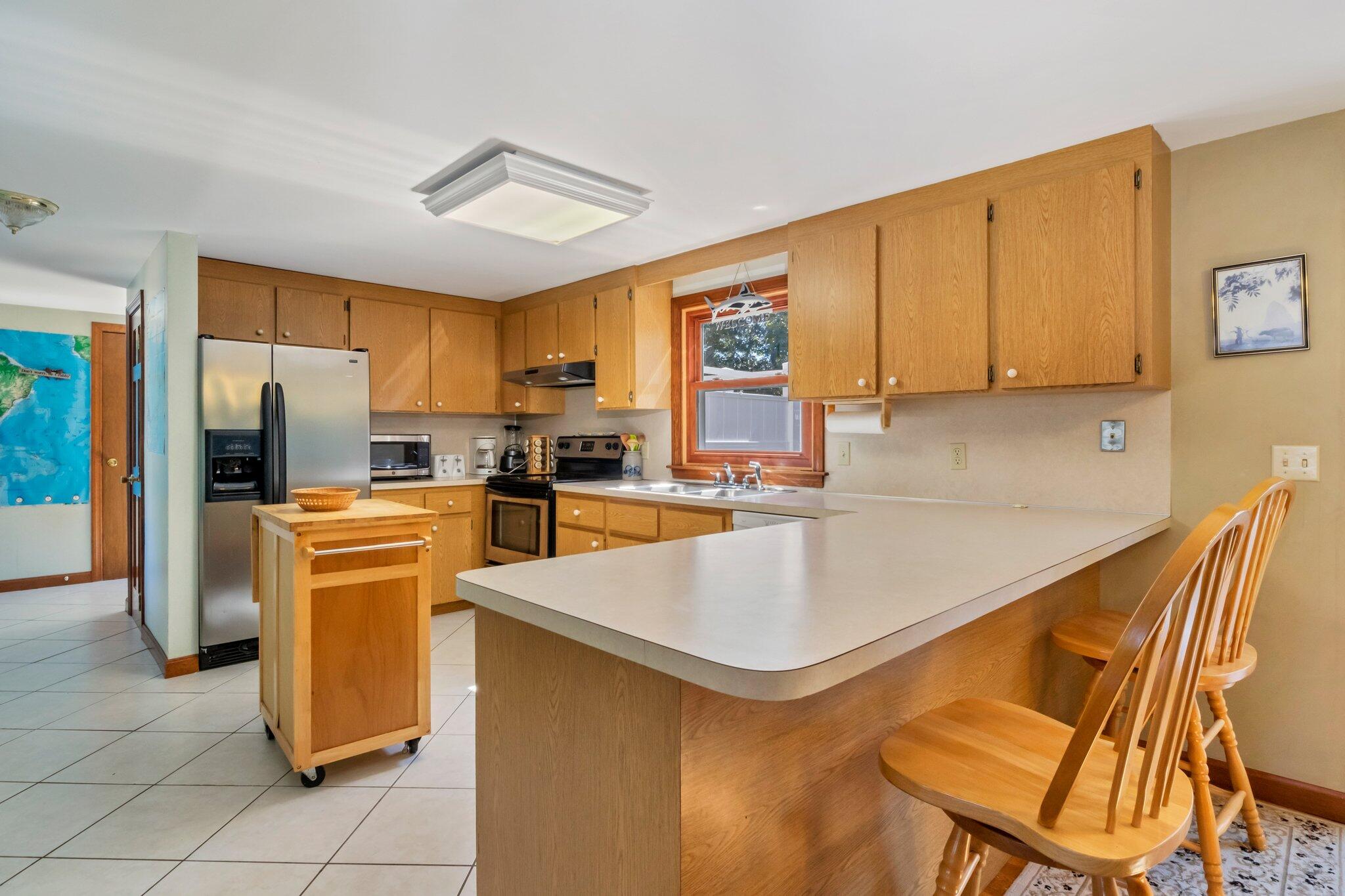 15 Chipmunk Lane Eastham, MA 02642 - Photo 10 of 32 a kitchen with cabinets and stainless steel appliances