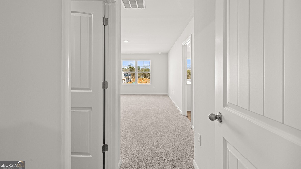 3253 Ryker Road, Unit 304 Gainesville, GA 30507 - Photo 14 of 32 a view of a hallway with wooden floor and closet area