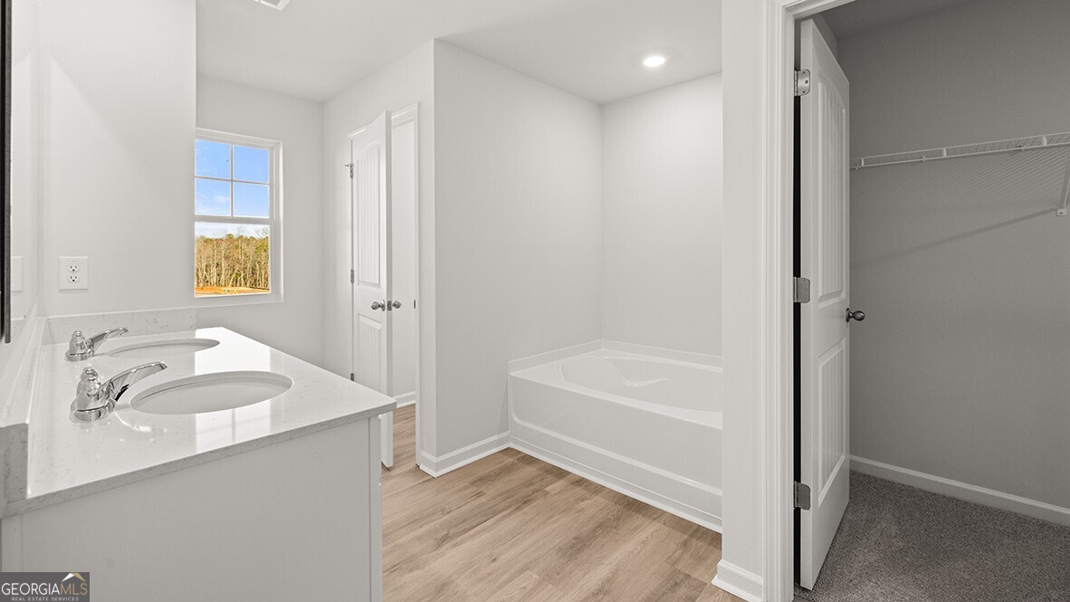 3253 Ryker Road, Unit 304 Gainesville, GA 30507 - Photo 19 of 32 a bathroom with a tub sink and a mirror