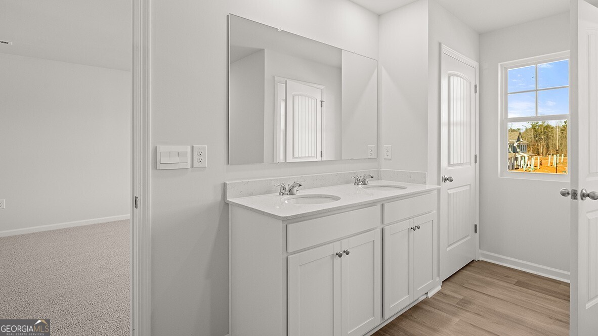 3253 Ryker Road, Unit 304 Gainesville, GA 30507 - Photo 20 of 32 a bathroom with a sink and a mirror