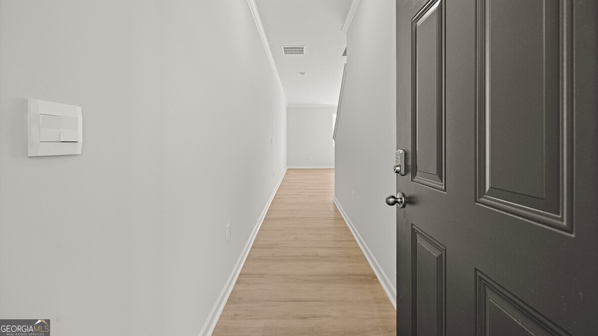 3253 Ryker Road, Unit 304 Gainesville, GA 30507 - Photo 2 of 32 a view of a hallway with wooden floor and staircase