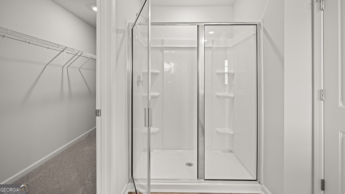 3253 Ryker Road, Unit 304 Gainesville, GA 30507 - Photo 22 of 32 a bathroom with a glass shower door