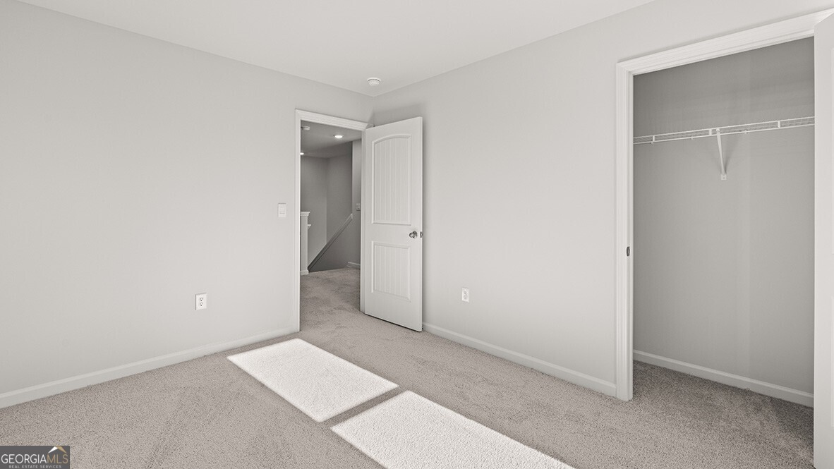 3253 Ryker Road, Unit 304 Gainesville, GA 30507 - Photo 23 of 32 an empty room with closet area
