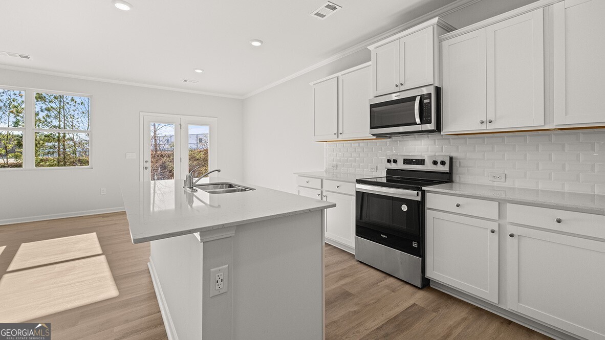 3253 Ryker Road, Unit 304 Gainesville, GA 30507 - Photo 5 of 32 a kitchen with stainless steel appliances white cabinets and sink