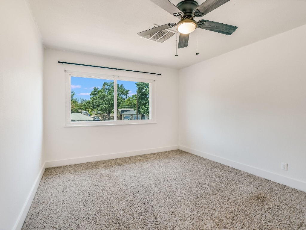 7617 Eastcrest Drive Austin, TX 78752 - Photo 12 of 20 an empty room with a window and a ceiling fan