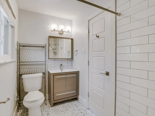 a bathroom with a toilet a sink and shower