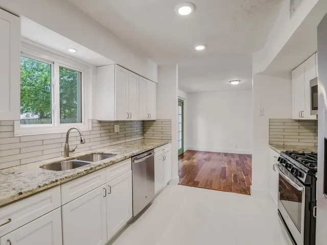 a kitchen that has a sink and a stove