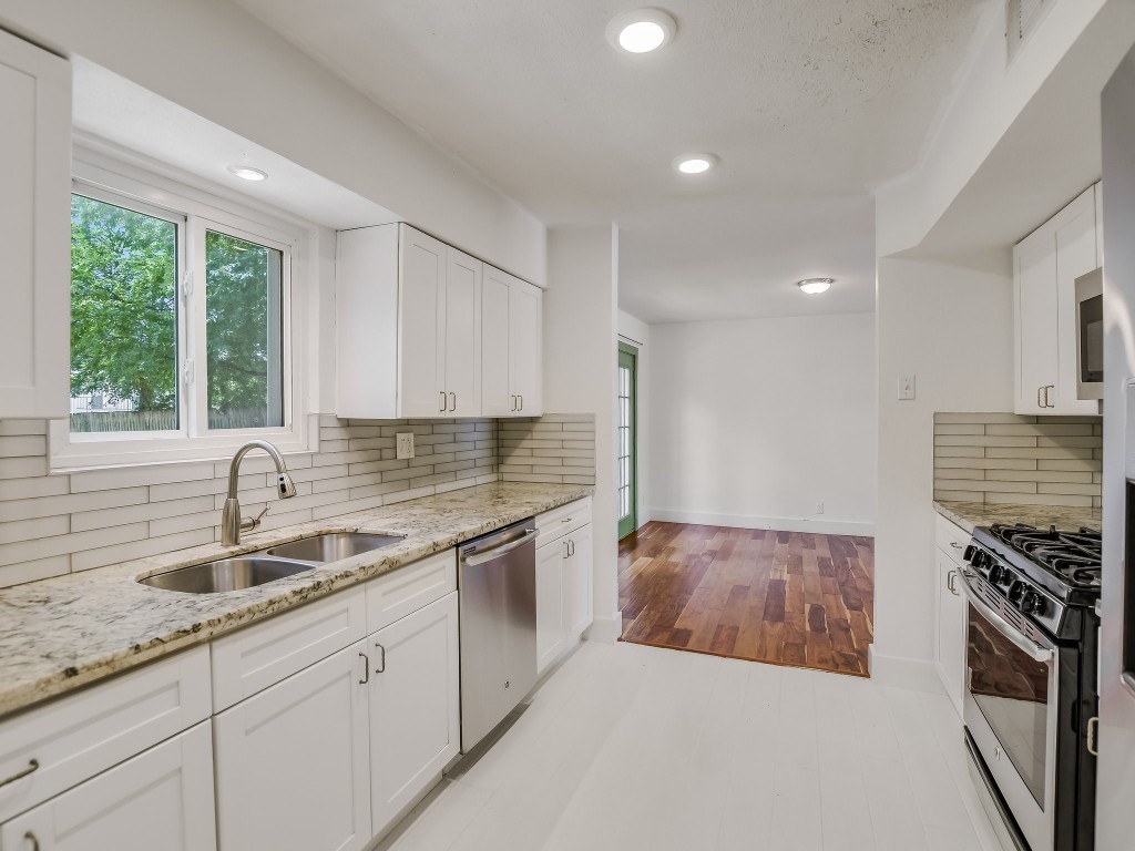 7617 Eastcrest Drive Austin, TX 78752 - Photo 9 of 20 a kitchen that has a sink and a stove