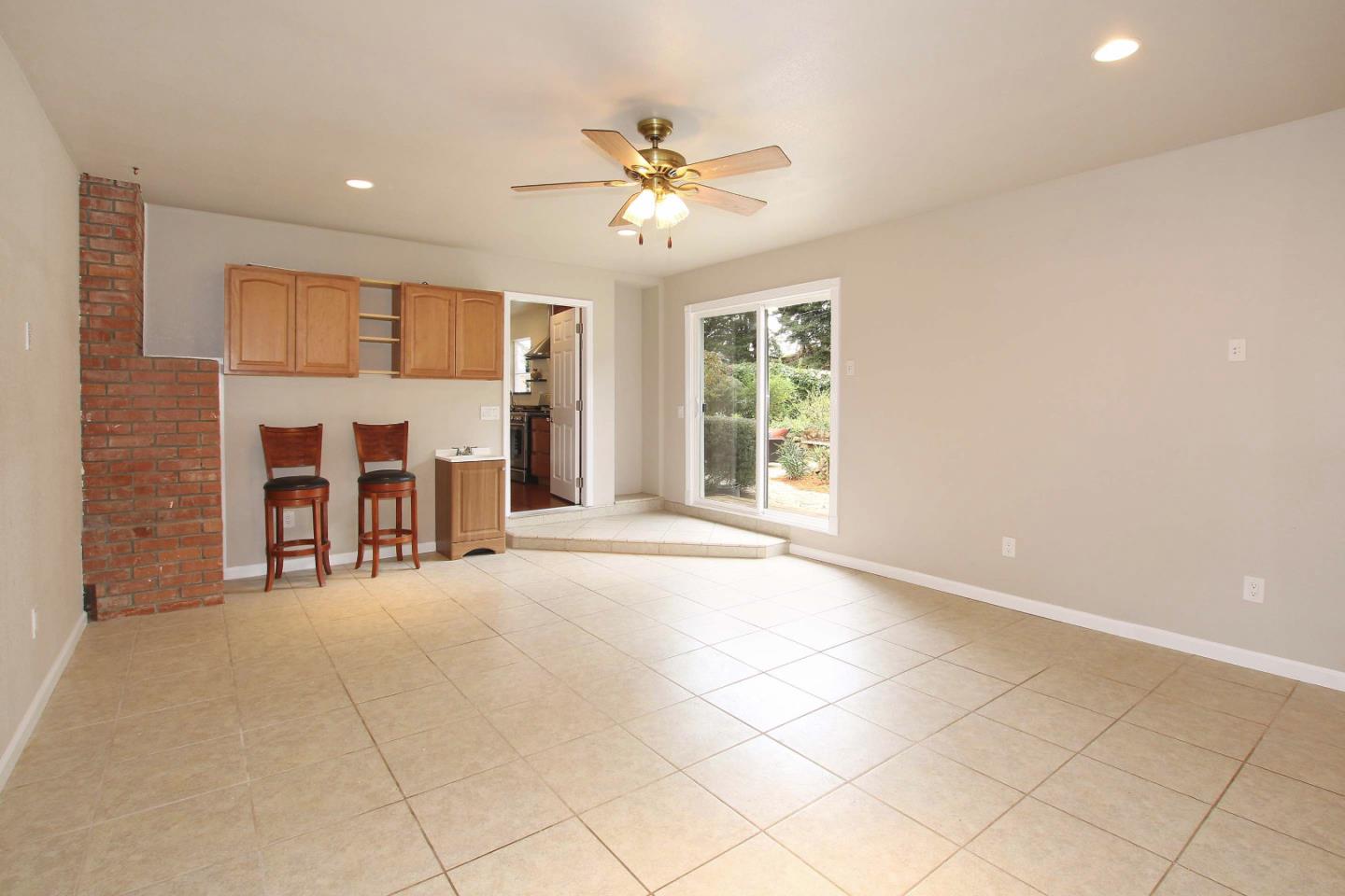 747 Calabasas Road Watsonville, CA 95076 - Photo 13 of 33 an empty room with windows and ceiling fan
