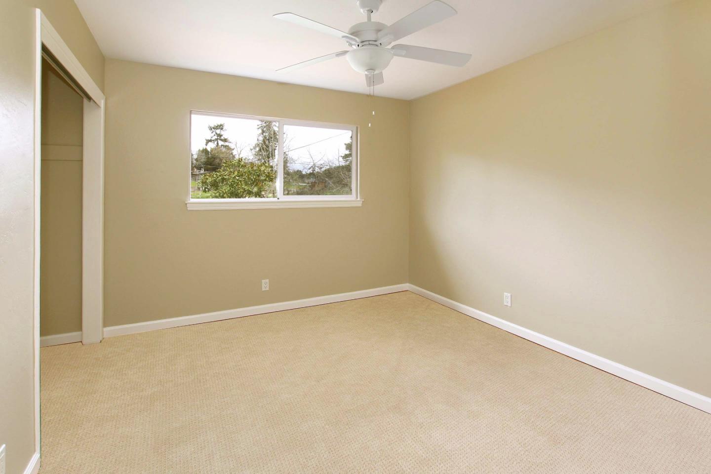747 Calabasas Road Watsonville, CA 95076 - Photo 19 of 33 an empty room with a window and a fan
