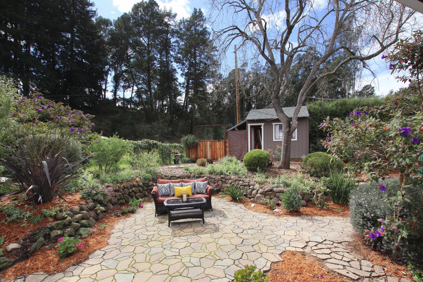 747 Calabasas Road Watsonville, CA 95076 - Photo 25 of 33 a bench sitting in middle of flower plants