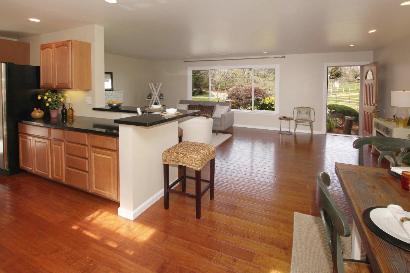 747 Calabasas Road Watsonville, CA 95076 - Photo 7 of 33 a living room with stainless steel appliances granite countertop furniture wooden floor and a view of kitchen