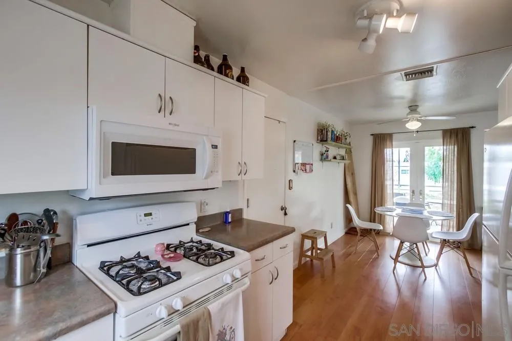 9449 Mandeville Road Santee, CA 92071 - Photo 12 of 20 a kitchen with a stove a refrigerator and wooden floor