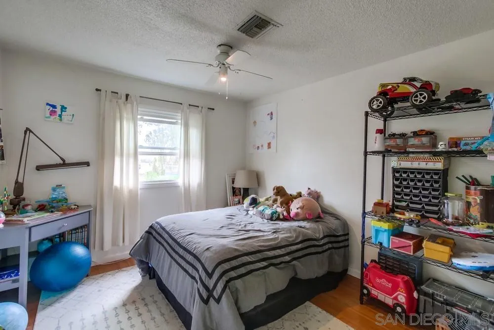 9449 Mandeville Road Santee, CA 92071 - Photo 16 of 20 a bedroom with a bed and a table in it