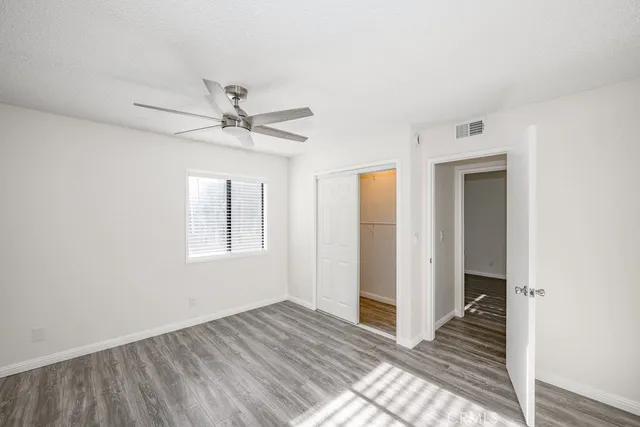 a view of a livingroom with a ceiling fan and window