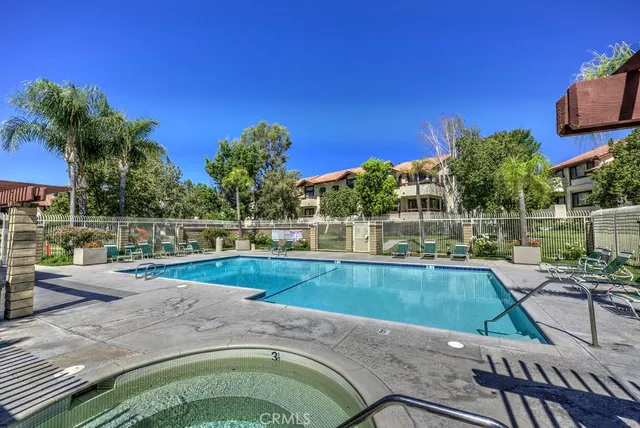 a view of a backyard with swimming pool