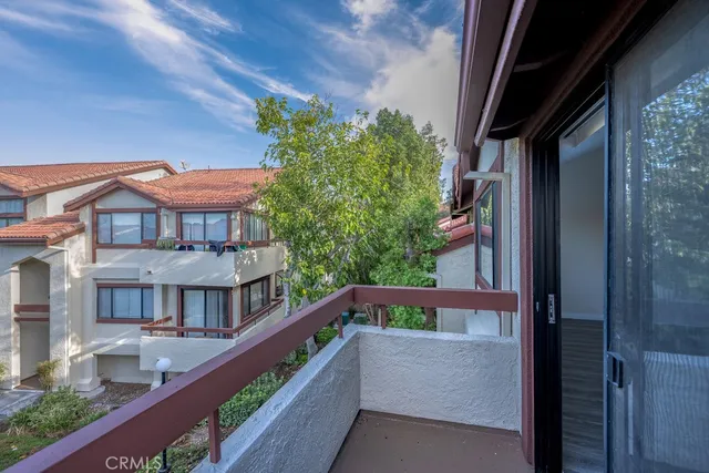 a balcony with wooden floor and plants