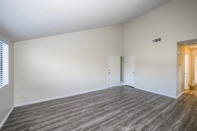 a view of an empty room and wooden floor