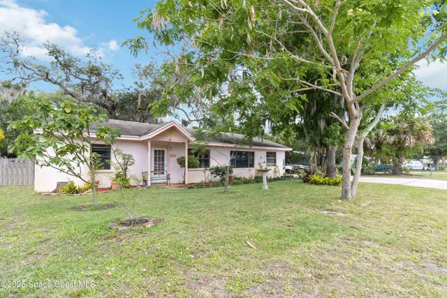 a house view with a sitting space and garden