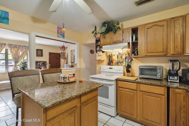 a kitchen with stainless steel appliances granite countertop a sink and cabinets