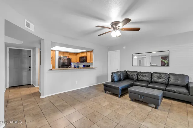 a view of a livingroom with kitchen and furniture