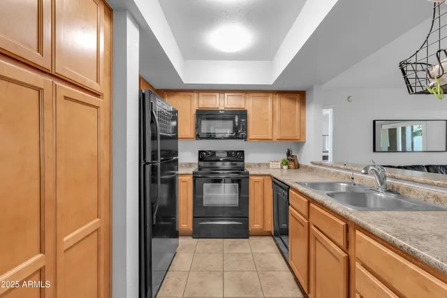a kitchen with stainless steel appliances granite countertop a sink stove and microwave