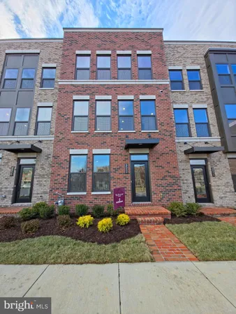 a view of a brick building next to a yard