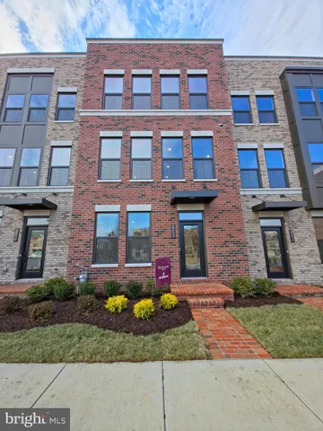 a view of a brick building next to a yard