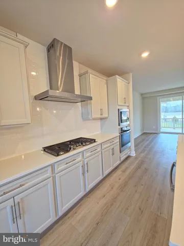 a kitchen with granite countertop a stove and a sink