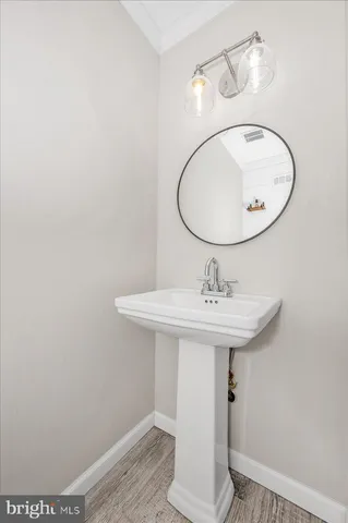 a bathroom with a sink a mirror and toilet