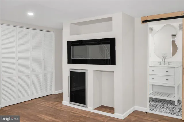a living room with a fireplace and a walk in closet