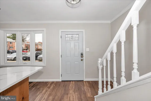 a view of an entryway with wooden floor