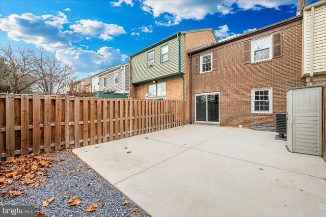a view of a house with a wooden fence