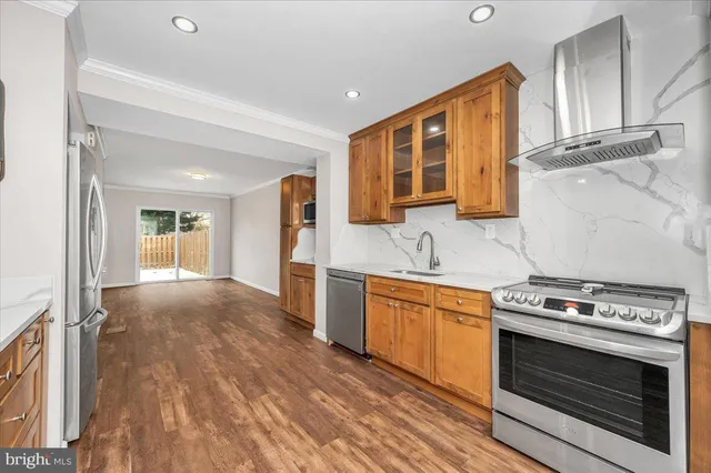 a kitchen with stainless steel appliances granite countertop a stove and a refrigerator